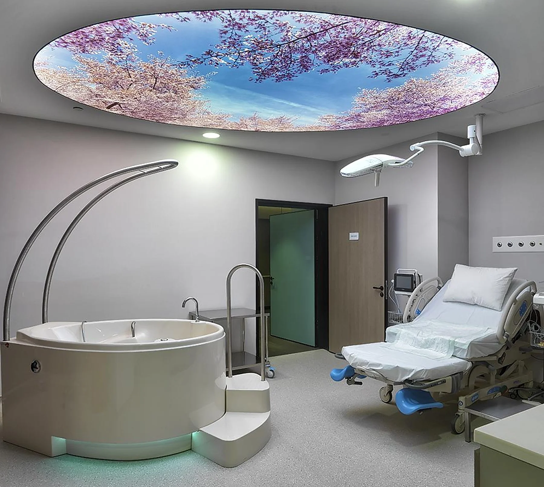 A birth suite at Memorial with a birthing pool and a cherry-blossom sky ceiling