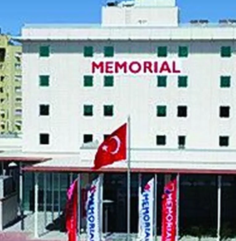 Memorial Antalya Hospital with Turkish and Memorial flags at the entrance