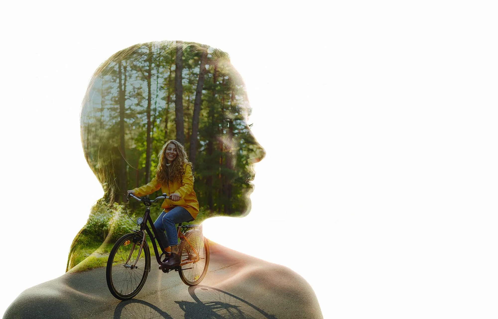 A woman cycling through a forest, seen inside the outline of a head, for women's check-ups at Memorial